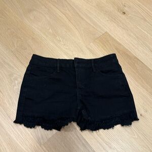 Black stretch shorts with a ruffle .